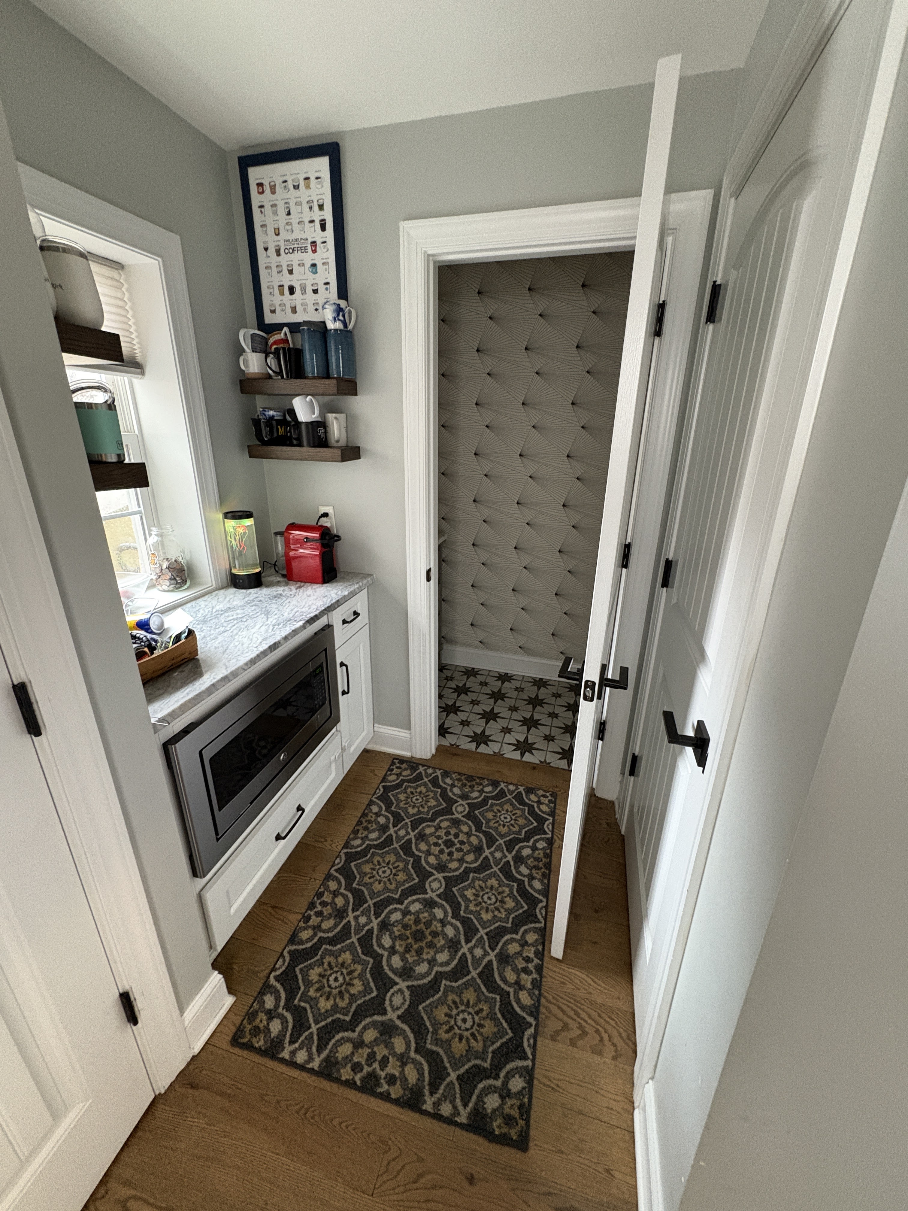 Hallway with built-in microwave and half bath